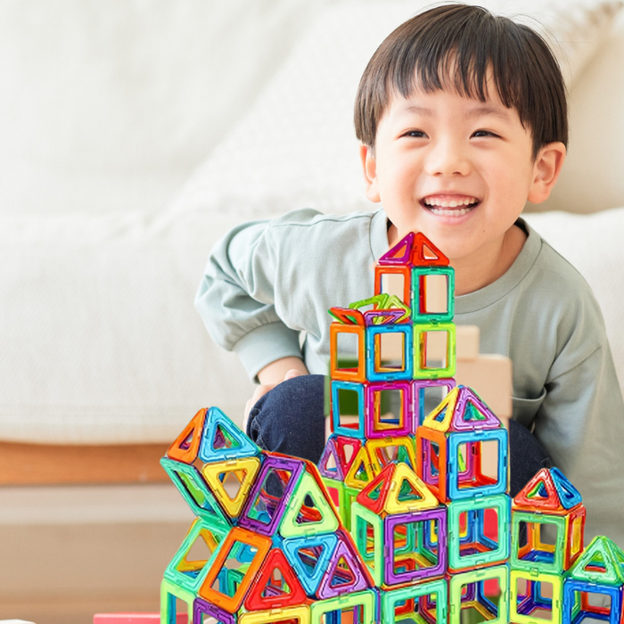 happy bot toddler playing magnetic building blocks