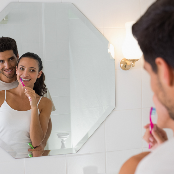 happy couple brushing their teeth