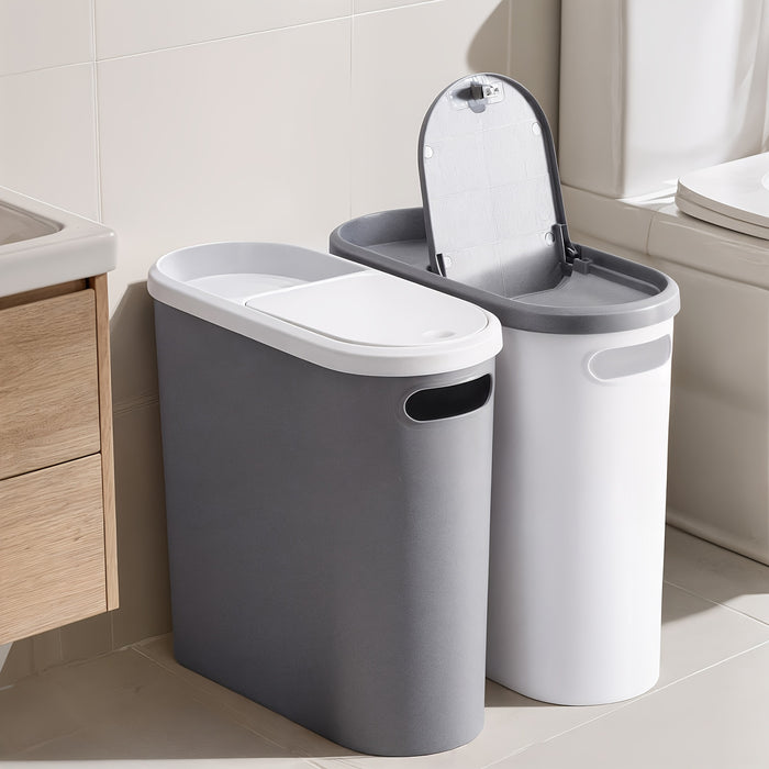 Two gray trash bins with one open in a bathroom setting.