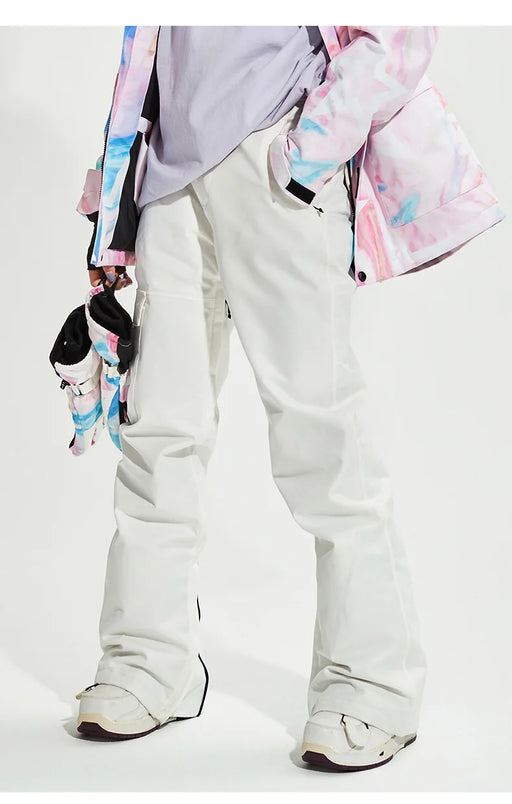White ski pants, side view with ski boots