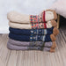 Stack of slipper socks in beige, navy and grey