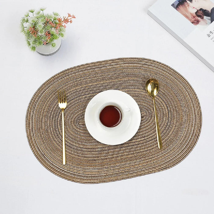 Coffee oval braided placemat with a cup and cutlery