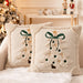 Two beige embroidered Christmas tree cushions