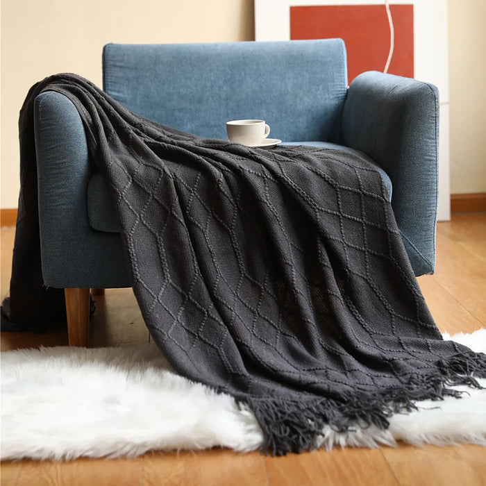 Smoky grey knitted throw on a blue armchair