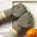 Pair of light grey fingerless gloves with the flaps buttoned back