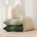 Cream and green textured cushions stacked on a chair