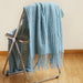 Lake blue bubble knit throw over a folding chair