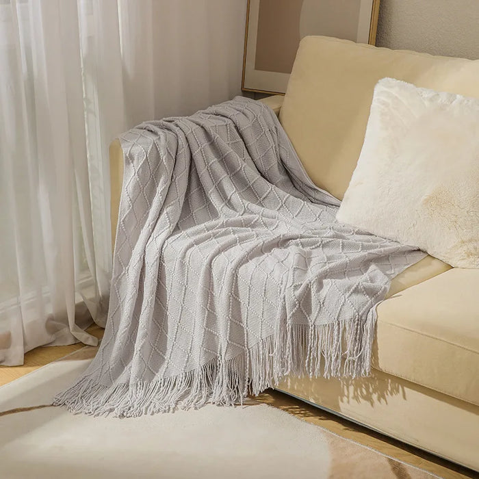 Light grey diamond knit throw on a cream sofa