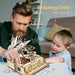 Father and child building the wooden piano music box together