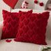 Two red heart pattern cushion covers on a sofa