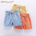 Kids' cotton linen shorts in light blue, yellow and orange