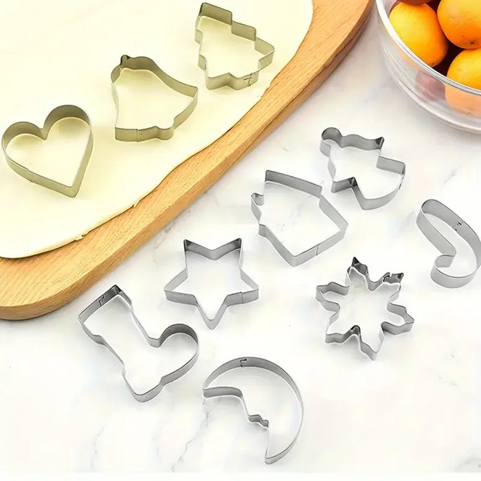 Stainless steel Christmas cookie cutters on a wooden board