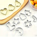 Stainless steel Christmas cookie cutters on a wooden board