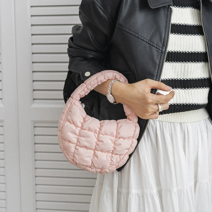 Woman holding a pink mini puffer tote