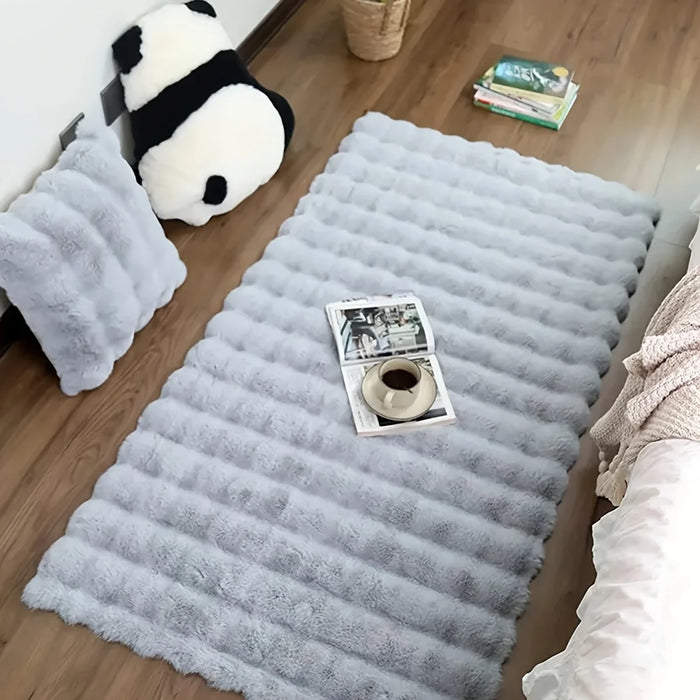 Grey faux fur bubble rug with a magazine and a panda pillow
