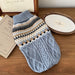 Blue cable-knit dog sweater laid flat