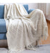 Cream white diamond knit throw on a sofa