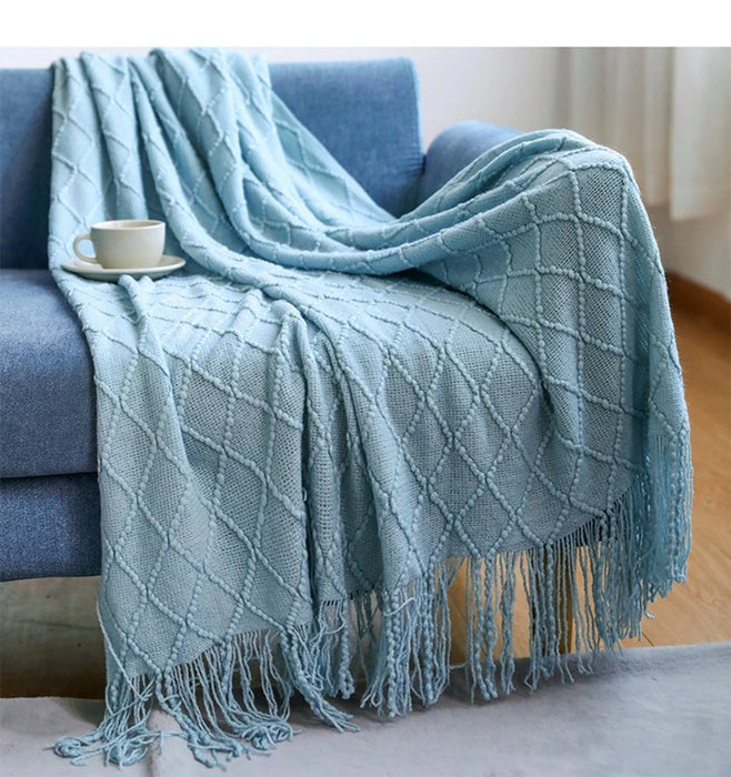 Light blue diamond knit throw on a sofa