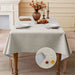 Off-white linen-look tablecloth on a dining table