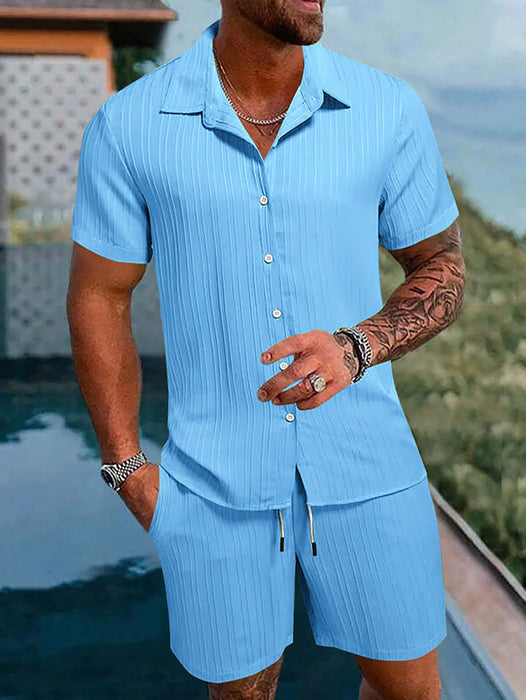 Man in a light blue textured short sleeve shirt and shorts set