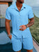 Man in a light blue textured short sleeve shirt and shorts set