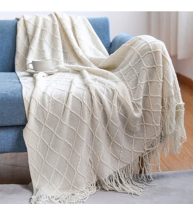 Beige diamond knit throw on a blue sofa