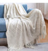 Beige diamond knit throw on a blue sofa