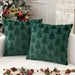 Two green plush Christmas tree cushions by a tree