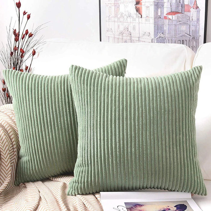 Bean green corduroy cushions on a sofa