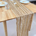 Khaki gauze runner on a light wood table