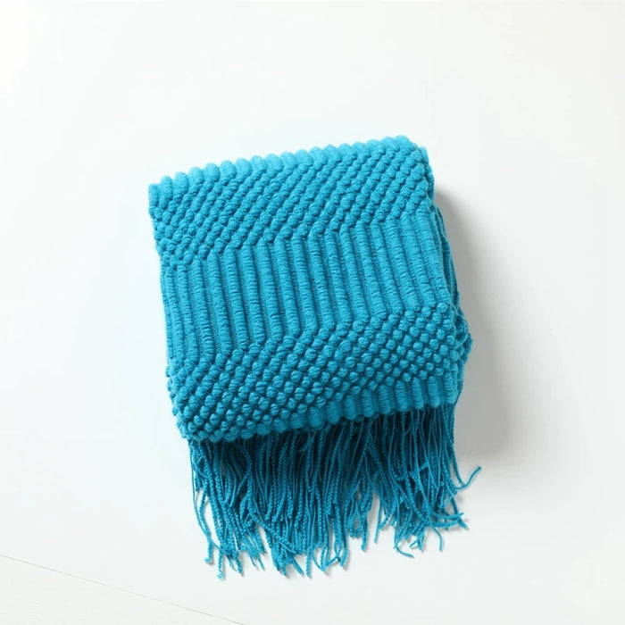 Folded peacock blue bubble knit throw