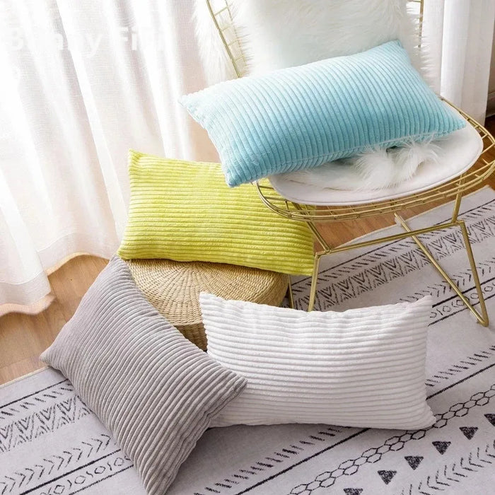 Corduroy cushions in blue, yellow, grey and white on a chair