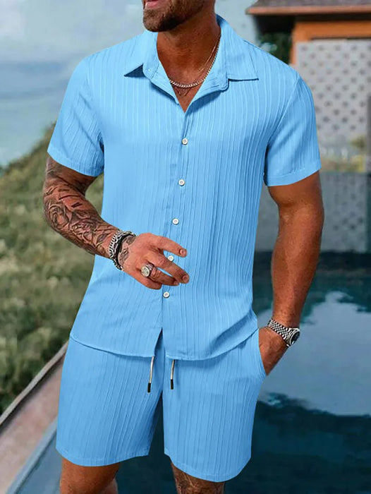 Man in a light blue short sleeve shirt and shorts set