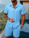 Man in a light blue short sleeve shirt and shorts set
