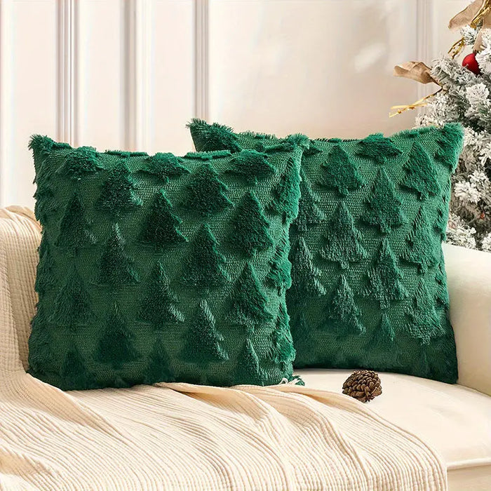 Two green plush Christmas tree cushions on a sofa