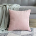 Skin pink corduroy cushion with a throw on a sofa
