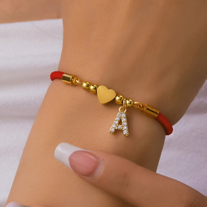 Initial heart charm bracelet with letter A on a wrist
