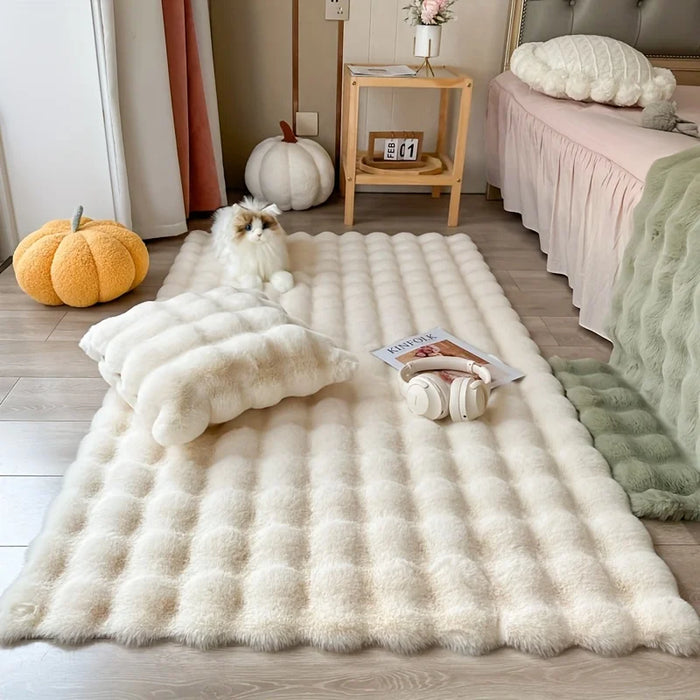 White faux fur bubble rug by a bed