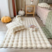 White faux fur bubble rug by a bed