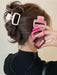Square claw clips in white, pink, magenta and wine red beside a twisted updo