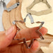 Hand holding a star cookie cutter over dough