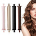 Four satin curling rods in pink, champagne, black and brown beside a woman with long wavy hair