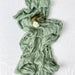 Sage green cheesecloth table runner with flowers