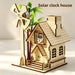 Solar clock house wooden model with a windmill