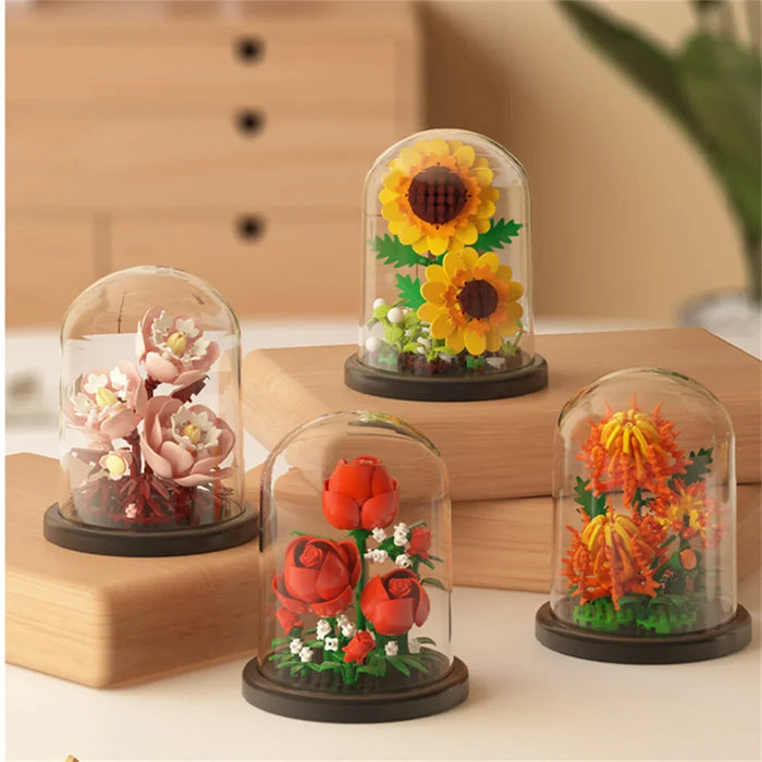 Sunflower, red rose and pink blossom bouquets in clear domes