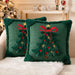 Two green embroidered Christmas tree cushions