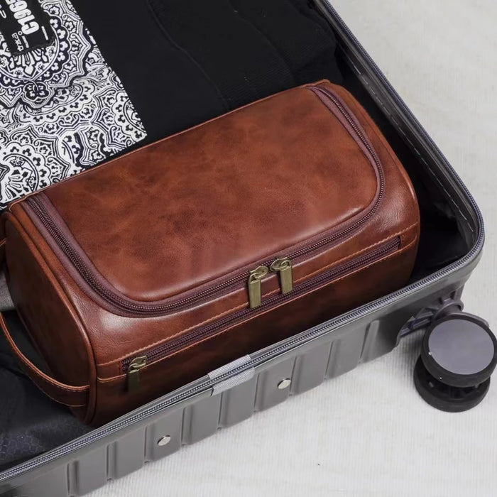 Brown toiletry bag packed in a suitcase