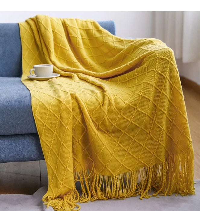 Yellow diamond knit throw on a blue sofa