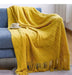 Yellow diamond knit throw on a blue sofa