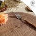 Close-up of a braided placemat with a fork and roses